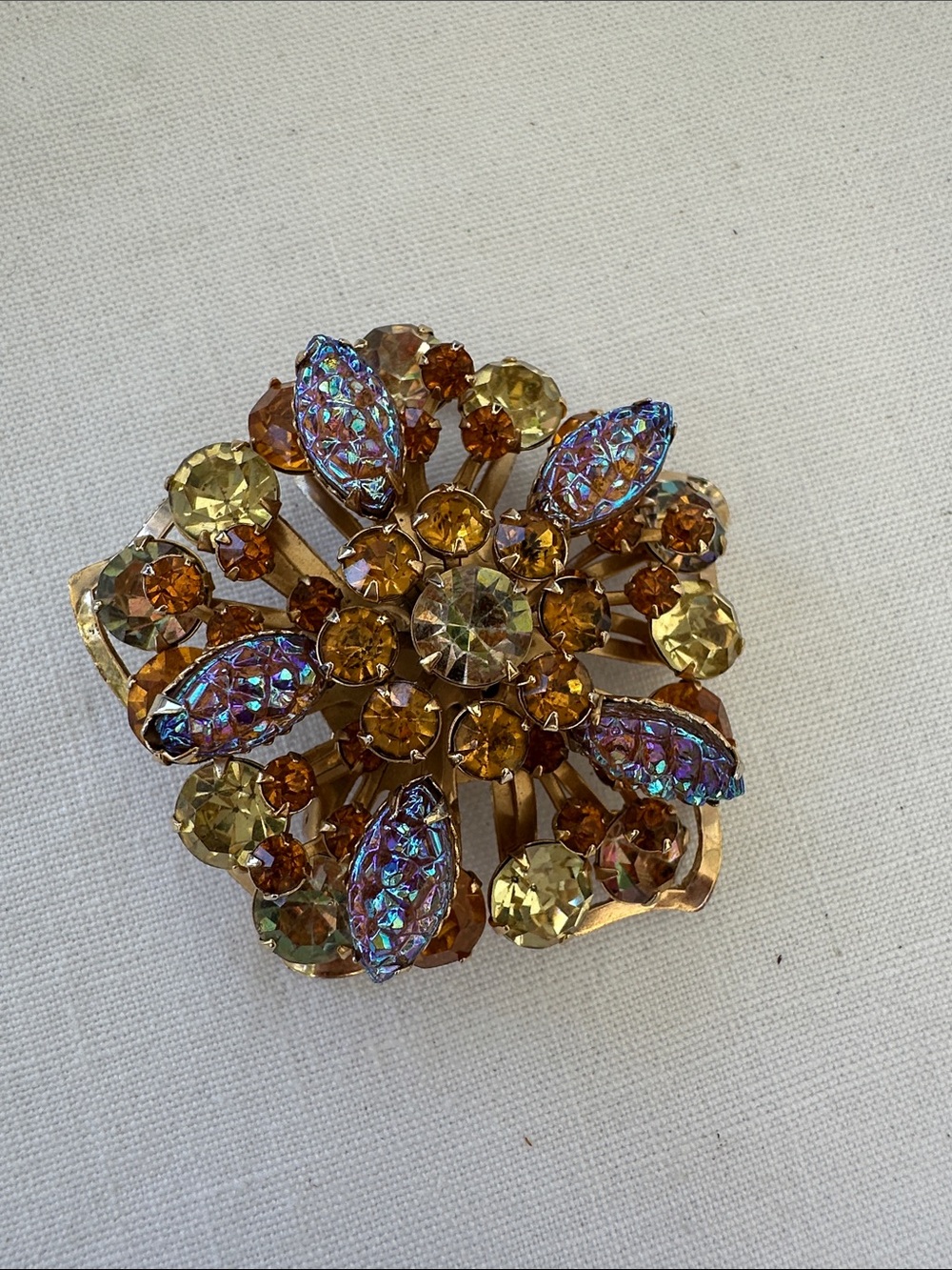 Vintage brooch with rhinestones and molded glass, flower, star shaped.
